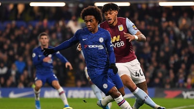 Willian holds off Tyrone Mings during the Premier League game at Stamford Bridge. Getty Images