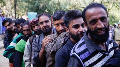 People stand in a queue to vote in south Kashmir's Kokernag. Reuters