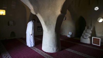 A man prays inside the Al Bidya Mosque. Silvia Razgova / The National