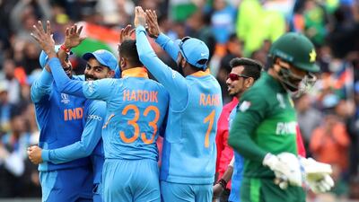 India players celebrate the dismissal of Pakistan batsman Mohammad Hafeez, right, during the Cricket World Cup match at Old Trafford. AP Photo