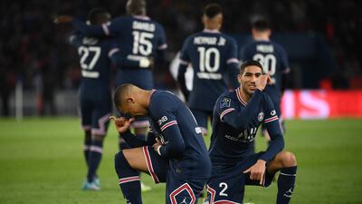 Kylian Mbappe celebrates with Achraf Hakimi (R) after scoring for PSG against Lorient. AFP