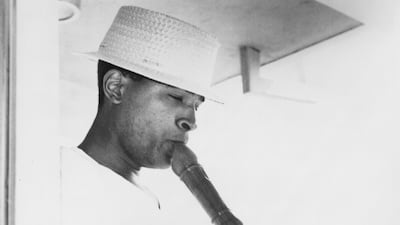 Soul singer Marvin Gaye plays clarinet as he performs onstage wearing a white cap in circa 1970. Getty Images