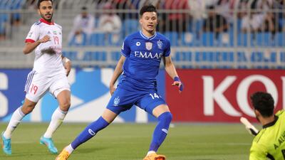 Hilal forward Abdullah al-Hamdan has his shot saved by Sharjah goalkeeper Adel al-Hosani.