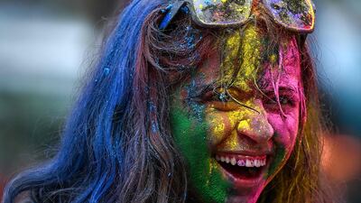 A woman covered in coloured powder celebrates the Hindu festival of Holi in Mumbai. AFP