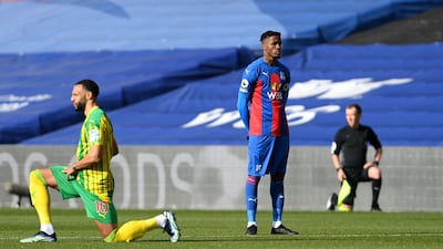 Crystal Palace's Wilfried Zaha stands while players take a knee prior to the Premier League match against West Brom at Selhurst Park on Saturday, March 13, 2021. PA