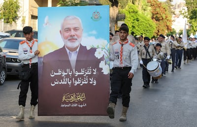 Members of Imam al-Mahdi scouts carry a picture depicting late Hamas leader Ismail Haniyeh, during a protest condemning his killing, in Sidon, Lebanon August 5, 2024. REUTERS