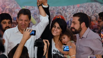 The presidential candidate for the Workers' Party, Fernando Haddad (left) and his running mate Manuela d'Avila (centre), addresses supporters in Sao Paolo. AFP