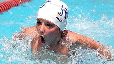 A student competes in the butterfly stroke at the Dubai Swimming Championships last Thursday.