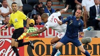 England's Glen Johnson, left, is tackled by France's Franck Ribery in Donetsk. Lindsey Parnaby / EPA