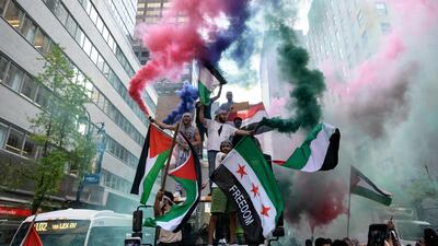 Demonstrators in midtown Manhattan, New York City, hold Palestine and Syrian flags in support of Palestinians in the Gaza Strip. AFP