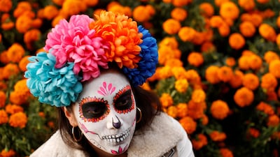 A woman dressed up as 'Catrina', a Mexican character also known as 'The Elegant Death', takes part in a Catrinas parade in Mexico City. Carlos Jasso / Reuters