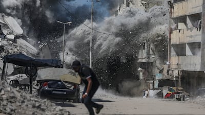 A Palestinian runs for cover as the Israel military bombards Gaza city. More than 66,000 Palestinians have been killed in the Gaza Strip since October 2023, the Palestinian Ministry of Health estimates. EPA