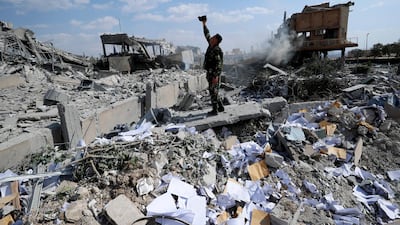 A Syrian soldier films the damage of the Syrian Scientific Research Center which was attacked by U.S., British and French military strikes to punish President Bashar Assad for suspected chemical attack against civilians, in Barzeh, near Damascus, Syria, Saturday, April 14, 2018. The Pentagon says none of the missiles filed by the U.S. and its allies was deflected by Syrian air defenses, rebutting claims by the Russian and Syrian governments. Lt. Gen. Kenneth McKenzie, the director of the Joint Staff at the Pentagon, also says there also is no indication that Russian air defense systems were employed early Saturday in Syria. AP Photo / Hassan Ammar