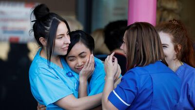 NHS workers at the Aintree University Hospital react during the last day of the Clap for our Carers campaign in support of the NHS in Liverpool, Britain. Reuters