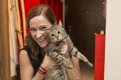 Sulafa Tower resident Carla Julian saw firefighters bring birds, dogs and cats to safety. She was at home when the fire started and quickly took her cat, Miss Bradshaw, outside. Antonie Robertson / The National