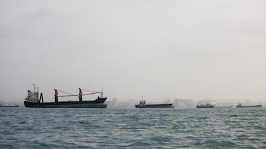 BANDAR ABBAS, IRAN - AUGUST 10: Ships are anchored in the Strait of Hormuz on August 10, 2026 off the coast of Bandar Abbas, Iran. In a recent statement, Iran's Supreme National Security Council said the vital waterway would not reopen until the United States "corrects its behavior," demanding that the U.S. end its war on Iran and compensate the country for war damage, among other conditions. Iran has largely halted vessel traffic through the strait with the threat of strikes; meanwhile, the U.S. has imposed a blockade on Iranian ports. (Photo by Ali Saeedi / Getty Images)