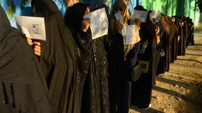 Afghan women voters queue prior to casting their ballot at a polling station amid tight security as voting got under way. AFP