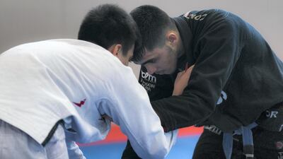 Omar Al Fadhli, in black, is part of the UAE jiu-jitsu team alongside Faisal Al Ketbi at the 2018 Asian Games in Indonesia. Reem Mohammed / The National