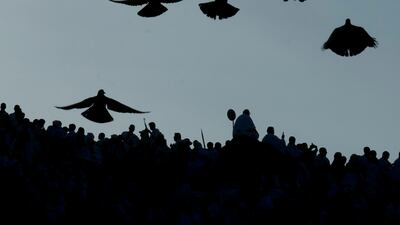 Pigeons fly as Muslim pilgrims pray on top of the rocky hill known as the Mountain of Mercy, on the Plain of Arafat, during the annual hajj pilgrimage, near the holy city of Mecca, Saudi Arabia. One million pilgrims from across the globe amassed on Thursday in the holy city of Mecca in Saudi Arabia to perform the initial rites of the hajj, marking the largest Islamic pilgrimage since the coronavirus pandemic upended the annual event — a key pillar of Islam. AP Photo