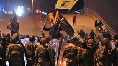 Supporters of Lebanese Shiite groups Hezbollah and Amal wave flags in front of army soldiers in the capital Beirut, Lebanon. AFP