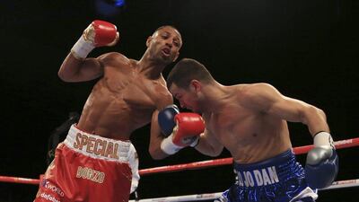 Kell Brook, left, throws Jo Jo Dan a left uppercut during the IBF World Welterweight Championship bout at the Motorpoint Arena in Sheffield, England Saturday, March 28, 2015. Brook retained his IBF welterweight belt when mandatory and outclassed challenger Dan threw in the towel after their fourth round and four knockdowns on Saturday. (AP Photo/PA, Nick Potts)