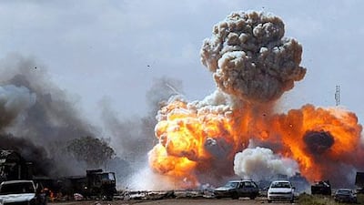 Military vehicles of pro-Qaddafi forces are hit by revolutionary forces in a battle on the Benghazi and Ajdabiyah road in March.