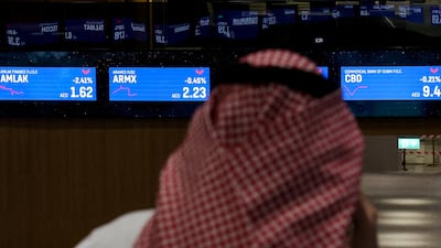 Screens display stock information at the Dubai Financial Market. UAE companies raised $1.1 billion through three IPOs last year. Reuters