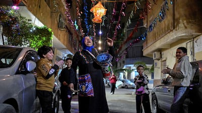 An Egyptian woman performs the role of musaharati, walking streets in Cairo and beating a drum to wake residents for suhoor. AFP
