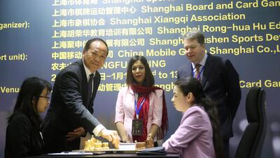 Iran chess referee Shohreh Bayat wearing headscarf around her neck looks on during the Women's World Chess Championship in Shanghai. Lewis Liu/FIDE via Reuters