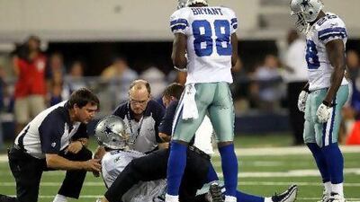 Tony Romo lies on the field after suffering the injury against the Giants in October that was to end his season.