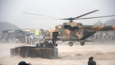 An Afghan military helicopter rescues people from atop an overturned truck in flooded area of Arghandab district in Kandahar province. AFP