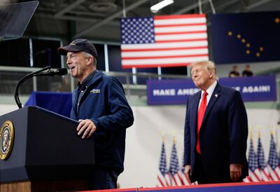Republican Senator Dan Sullivan speaks on stage as President Donald Trump looks on in Wasilla, Alaska, on October 13. Reuters
