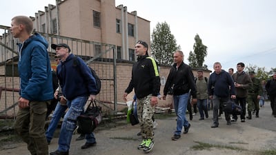 Russian recruits walk past a military recruitment centre in Volgograd, Russia. AP