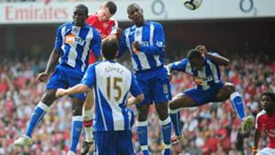 Arsenal's Thomas Vermaelen, centre, heads home the opener at the Emirates Stadium.