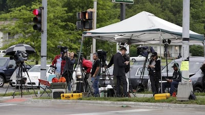 Media wait outside the main gate of Fort Leavenworth prison in Kansas on May 17, 2017, trying to get a shot of Chelsea Manning leaving the facility. Colin E Braley / EPA