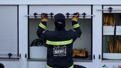 A team member prepares rescue equipment as part of the drill