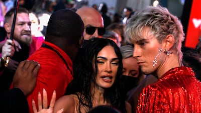 Irish mixed martial artist Conor McGregor (L) tries to push his way through toward US rapper Machine Gun Kelly (R) as US actress Megan Fox (C) stands in the middle as what appears to be a fight breaks out between the two men during the arrivals on the red carpet for the MTV Video Music Awards at the Barclays Center in Brooklyn, New York, USA, 12 September 2021. EPA / JASON SZENES