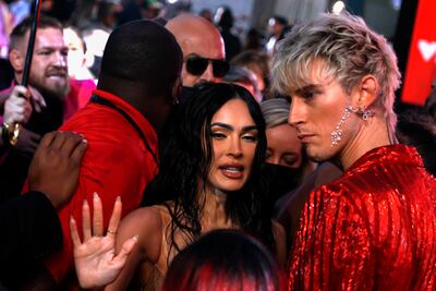 Irish mixed martial artist Conor McGregor (far left) tries to push his way through towards Machine Gun Kelly and Megan Fox on the MTV Video Music Awards red carpet on September 12, 2021. EPA