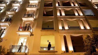 People look out from balconies to view a demonstration near the home of former prime minister Saad Hariri in central Beirut on December 16, 2019. AFP