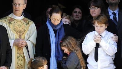 Mimi O'Donnell, centre, the estranged partner of the late actor Philip Seymour Hoffman, comforts her daughter Tallulah, along with daughter Willa, left, and son Cooper, at his funeral on Friday. Jason DeCrow / AP
