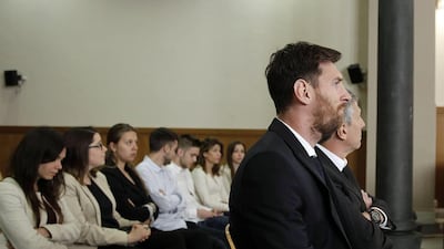 Lionel Messi, second right, and his father, Jorge Horacio Messi, right, attend a session of their trial in Barcelona, Spain. Alberto Estevez / Reuters