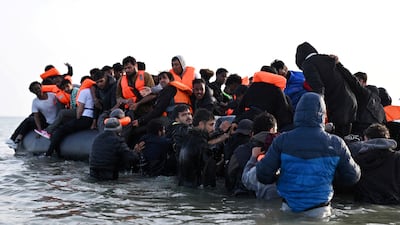 A group of asylum seekers board a boat in northern France to cross the English Channel. Reuters