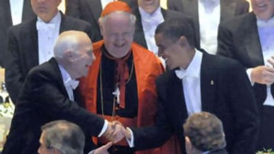 John McCain, left, and Barack Obama shake hands at the Alfred E Smith Memorial Foundation Dinner at the Waldorf Astoria in New York City yesterday while Cardinal Edward Egan, head of the Archdiocese of New York, centre, looks on.