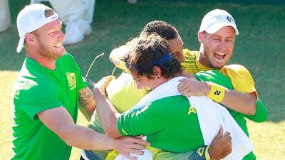 Sam Groth, Thanasi Kokkinakis and Nick Kyrgios run on court to congratulate teammate Lleyton Hewitt as he celebrates the victory that sent Australia through to the DavisCup semi-finals. Scott Barbour / Getty Images)