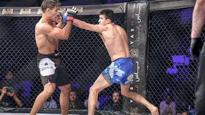 Brave Combat Federation 27 at the Mubadala Arena. Lightweight: (Left) Anas Siraj Mounir (TUN) gets a jab to the jaw by Alex Martinez (CAN) during the opening round of their bout. Victor Besa / The National