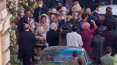 Lady Gaga, wearing a wedding dress in background left, plays Maurizio Gucci's former wife Patrizia Reggiani. AP photo