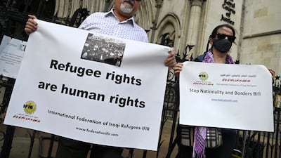 Demonstrators protest outside the Royal Courts of Justice in London, while a legal case is heard over halting a planned deportation of asylum seekers from Britain to Rwanda. Reuters