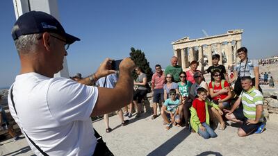 A group of tourists pose for a picture in front of the temple of the Parthenon atop the Acropolis in Athens, Greece, July 2, 2015. prime minister Alexis Tsipras called on Greeks to vote ‘no’ in Sunday’s referendum on a bailout package offered by creditors, in a defiant address that dispelled speculation he was rowing back on the plan under mounting pressure. Jean-Paul Pelissier / Reuters