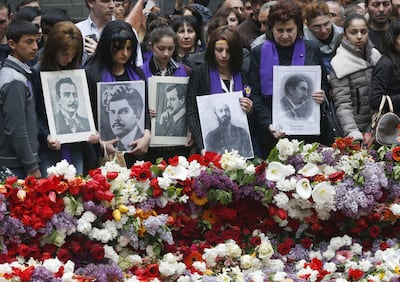 People lay flowers at a memorial to Armenians killed by the Ottoman Turks, as they mark the centenary of the mass killings. AP