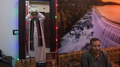 A Muslim singer wears his sufi clothing before singing Islamic songs at his home in Cairo, Egypt. EPA